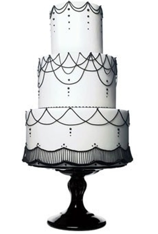 A white wedding cake decorated with black beads and patterns is a stylish and timeless idea to rock