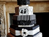 a black and white Halloween wedding cake with geometric tiers, various patterns and Corpse Bride and her groom silhouettes