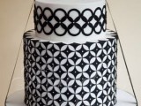 a bold black and white wedding cake with a geometric print and some black ribbon for a bold modern wedding
