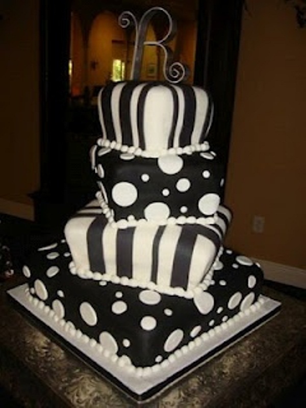 A bold square wedding cake imitating pillows in black and white, with polka dots and stripes