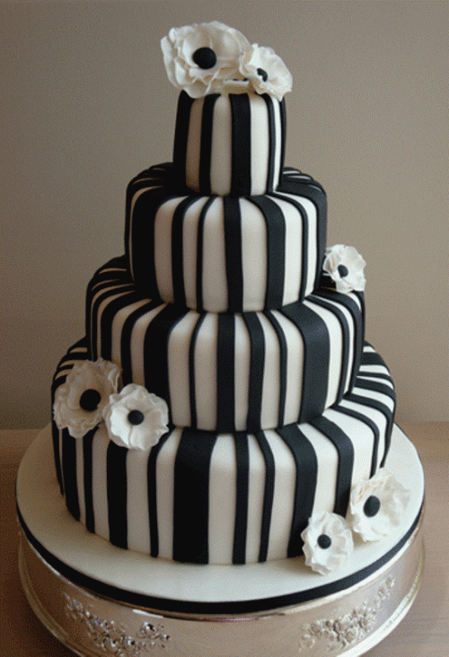 a fully striped black and white wedding cake topped with anemones is a bold and eye-catchy idea