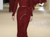 a fully embellished deep red wedding dress with a belt and long sleeves is a cool and really unique idea