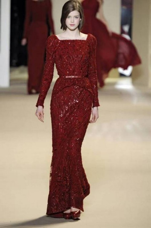 a fully embellished deep red wedding dress with a belt and long sleeves is a cool and really unique idea