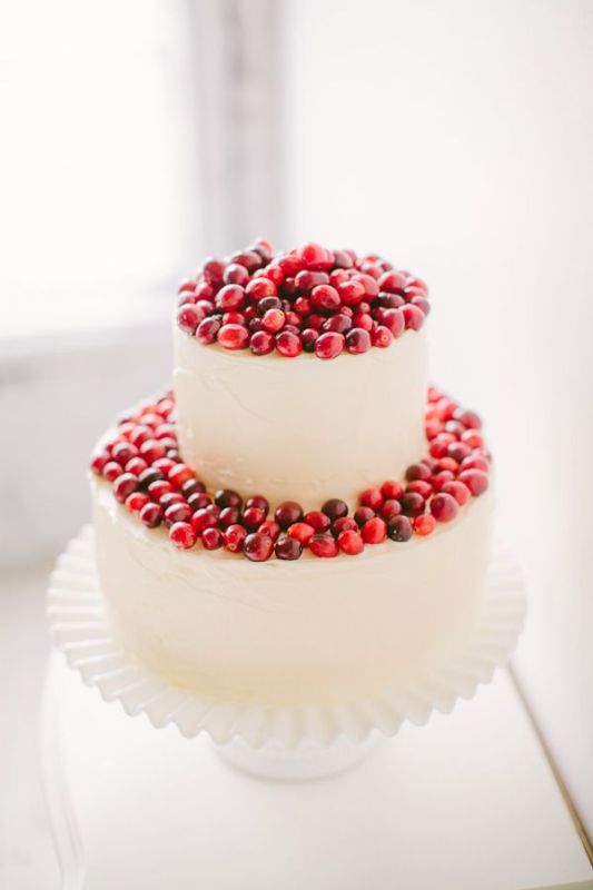 a buttercream wedding cake topped with cranberries is a cool and delicious idea with a fresh touch