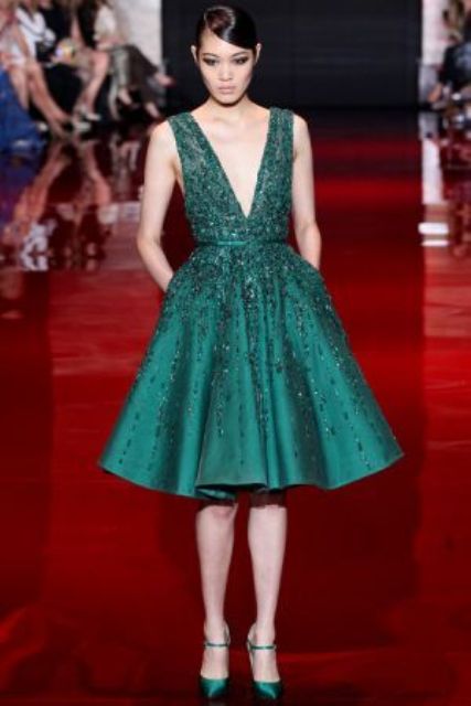 an emerald green knee A-line bridesmaid dress with no sleeves, a deep V-neckline and embellishments all over the dress is a jaw-dropping idea