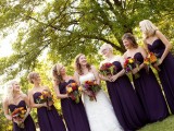 deep purple strapless maxi bridesmaid dresses are a great statement for a fall wedding, they are great for dark and moody celebrations