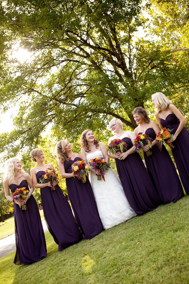 deep purple strapless maxi bridesmaid dresses are a great statement for a fall wedding, they are great for dark and moody celebrations