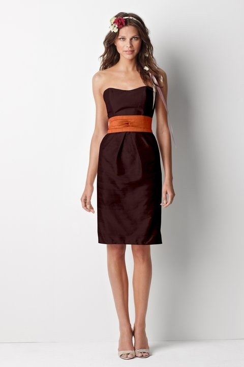 a brown strapless knee fitting bridesmaid dress spruced up with an orange sash is a chic and beautiful idea with plenty of color
