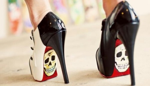 black and white high heels with red bottoms and skulls on them are a fantastic idea to make a bold statement at a Halloween wedding