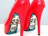 shiny red high heels with sugar skulls painted on the bottoms are a unique and creative solution for a Halloween bride