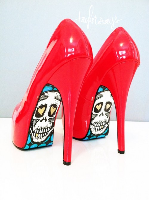 shiny red high heels with sugar skulls painted on the bottoms are a unique and creative solution for a Halloween bride