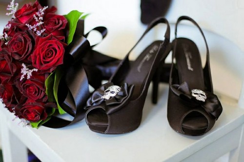 black peep toe slingbacks with black bows and skulls pinned to the front are a chic and bold idea for a Halloween or Gothic bride