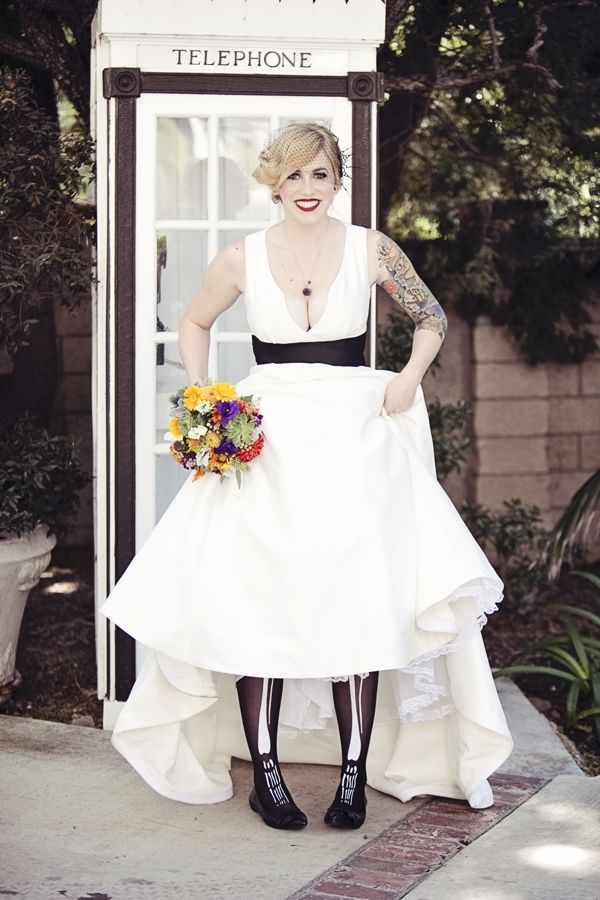 Black shoes paired with skeleton tights are a creative idea for a Halloween bride and they can be hidden with the dress when the bride wants