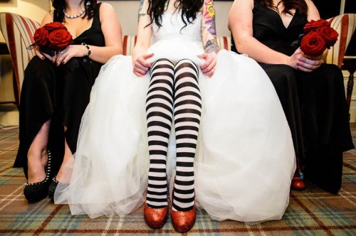 orange glitter shoes paired up with black and white stockings are a very playful and fun idea for a Halloween wedding