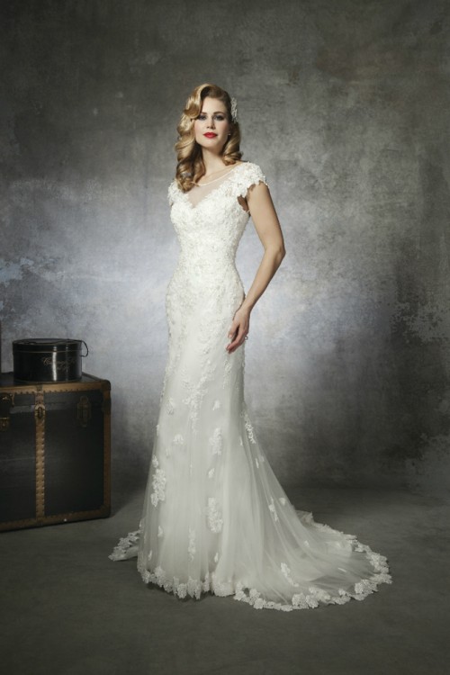 a lace mermaid wedding dress with an illusion V-neckline, cap sleeves, a train is a bold and catchy idea with a vintage feel