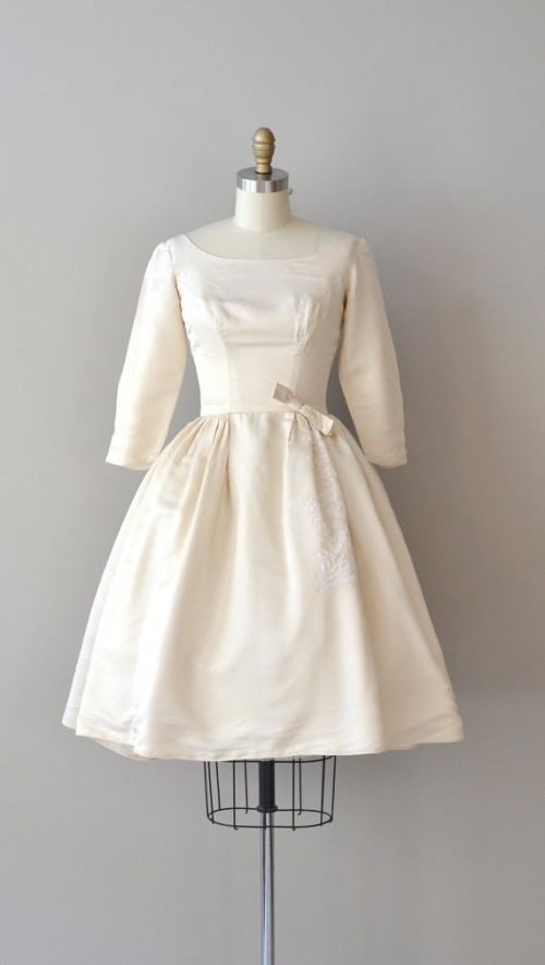 a plain A-line tea-length wedding dress with a pleated skirt, short sleeves, a square neckline is a stylish idea for a vintage or retro wedding