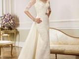 a refined lace fitting vintage wedding dress with a V-neckline, short lace sleeves, an embellished sash with an additional long train for a statement and vintage elegance