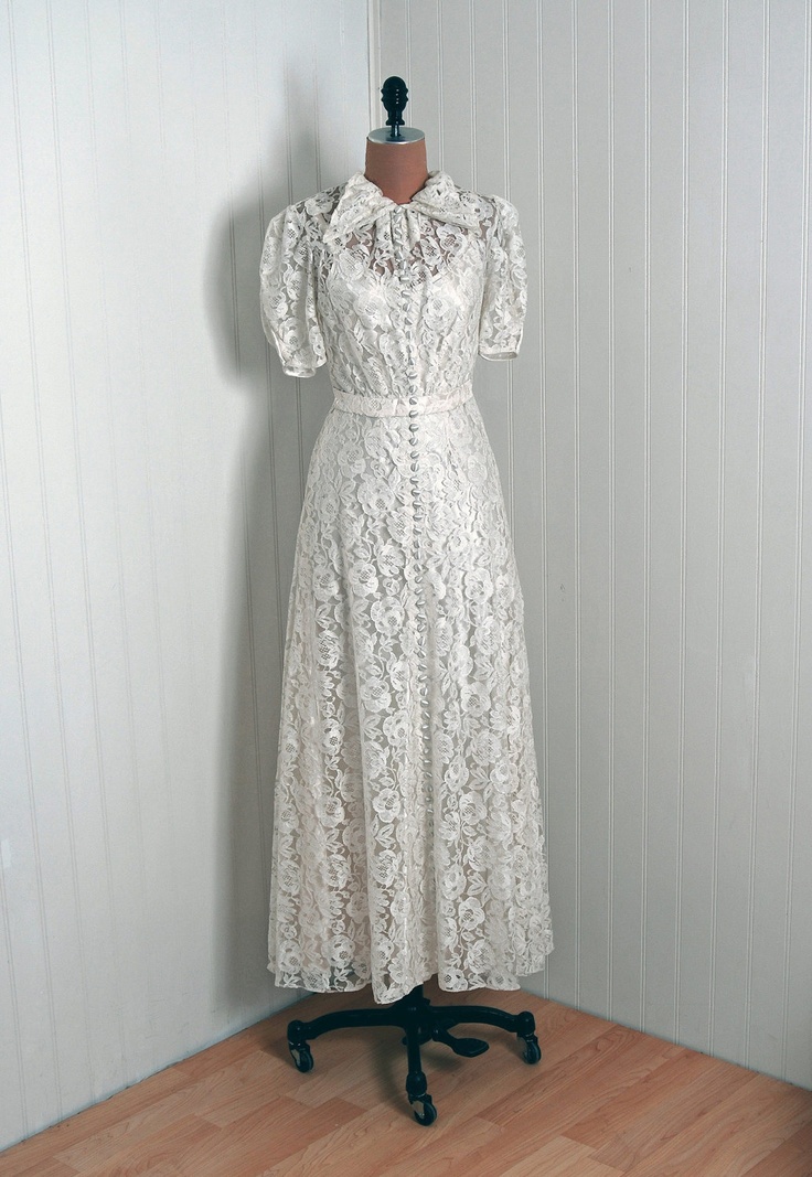 A chic lace tea length vintage inspired wedding dress with a shirt collar and short sleeves is amazing for a vintage wedding or a retro one