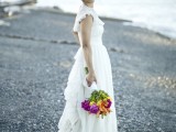 a vintage A-line wedding dress with ruffle sleeves, a ruffle tiered skirt and a train plus a high neckline for a vintage-loving and boho bride