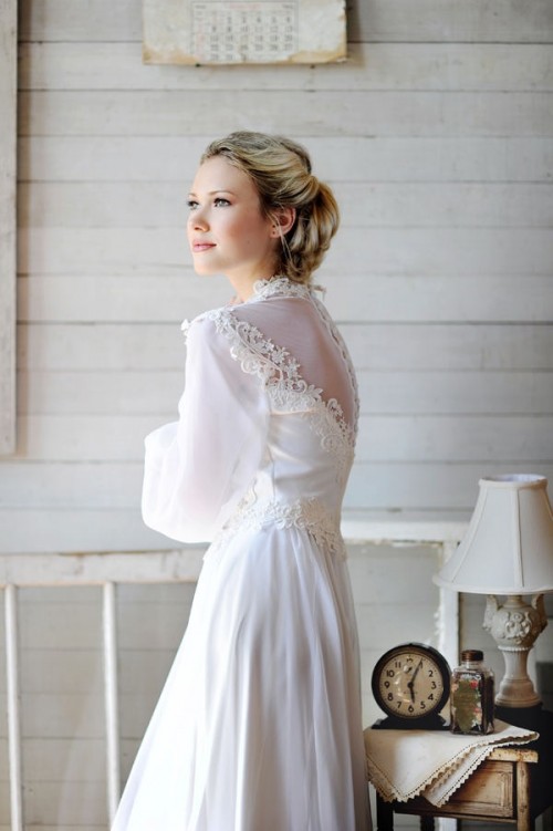 a beautiful vintage A-line wedding dress of plain fabric and lace, with puff sleeves, buttons on the back