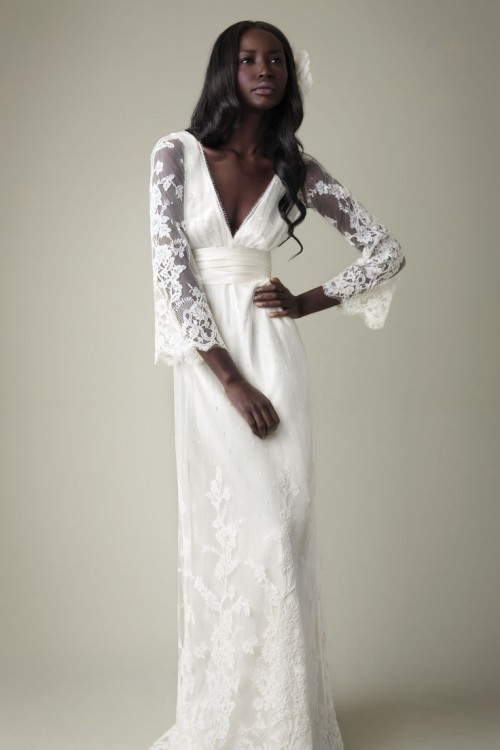 a refined and chic lace A-line wedding dress with a deep neckline, bell sleeves, a train and a matching headpiece are a gorgeous combo for a vintage wedding