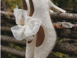 white lace cutout shoes with large bows look vintage and very sophisticated and bring a romantic feel