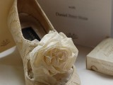 vintage ivory lace cutout wedding shoes with fabric blooms on top look stylish and refined
