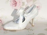white vintage cutout wedding shoes with ribbon bows look romantic and sophisticated