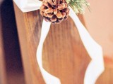 a pinecone, evergreens, ribbons will accent your wedding aisle in a natural and chic way