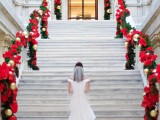 gorgeous bright garlands with evergreens, gold and red ornaments, red ribbon and bows make the railing cooler and brighter