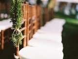 evergreens with white bows make the wedding aisle chic, natural and winter-like