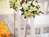 white bloom balls and berries plus red ribbon make the winter wedding aisle chic, cool and bright