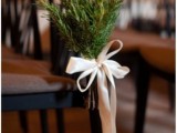evergreens with white ribbon bows will highlight your wedding chairs and refresh the look of the ceremony space