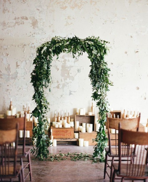 a lush greenery wedding arch will easily make your indoor ceremony feel more like an outdoor one