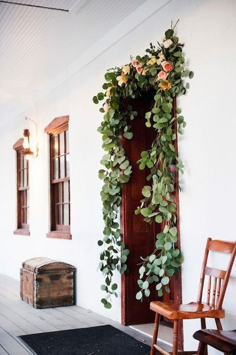 decorate wedding doorways with greenery and blooms to make your venue and ceremony space decor more romantic