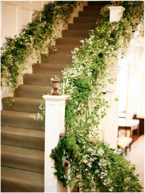lush greenery and white blooms covering the railings make the space feel fresh and bold and more outdoorsy