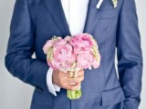 a navy suit, a white shirt, a midnight blue bow tie plus a romantic pink boutonniere