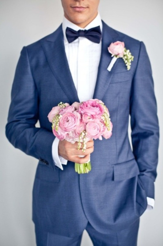A navy suit, a white shirt, a midnight blue bow tie plus a romantic pink boutonniere
