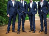 a navy suit, a navy tie, white shirt and brown shoes plus no ties for the groomsmen
