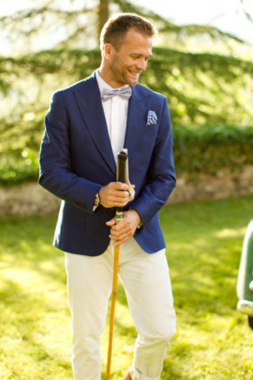 a navy blazer, a white shirt, a printed light blue bow tie and white pants create a contrasting look for your wedding