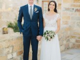 a chic navy suit, a white shirt and a grene tie plus brown shoes create a stylsih groom’s look