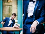 a navy three-piece wedding suit with silk lapels, a waistcoat, a white shirt and a black bow tie
