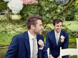 a navy suit, a white shirt, a grey tie and blush boutonnieres for a chic and elegant groom’s look