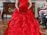 a fantastic hot red A-line off the shoulder wedding dress with a draped bodice and a ruffle skirt plus a bouquet of matching hot red roses for a modern wedding
