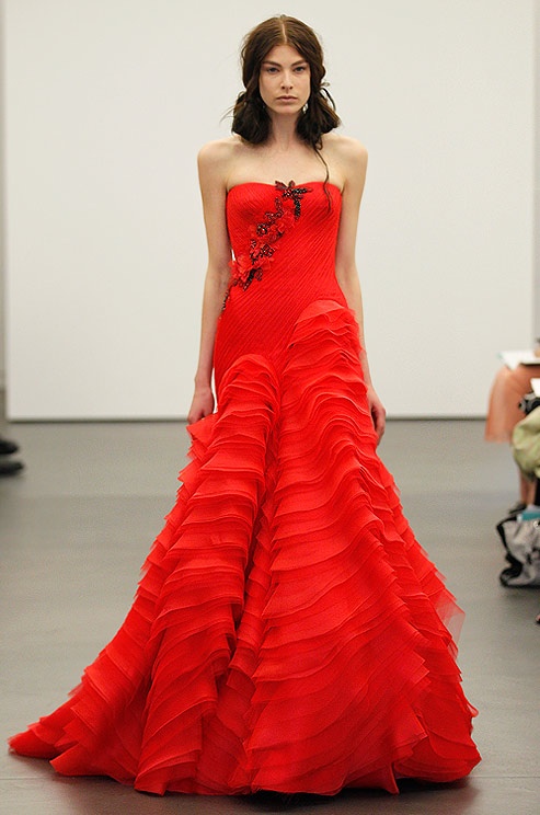 a hot red strapless A line wedding dress with a draped bodice and a ruffle skirt, black and red floral appliques is a bold idea to make a statement
