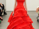 a hot red wedding dress with a lace and draped bodice, a ruffle skirt with a train is a bold modern statement to rock