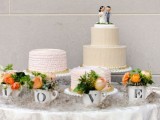 white wedding cake stands with simple neutral cakes and teacups with letters and blooms