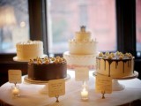 white wooden cake stands with an assortment of fun modern wedding cakes are a chic idea