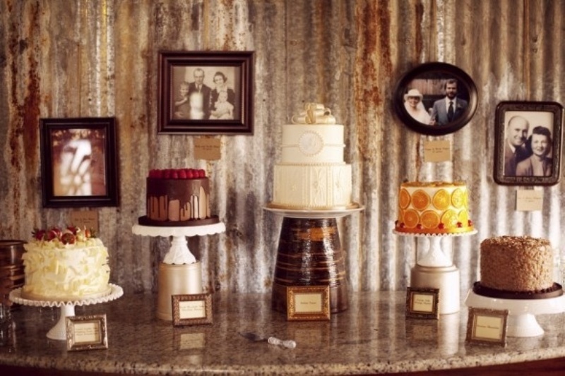 all different wedding cakes placed on white stands and a large metal one to highlight the main cake