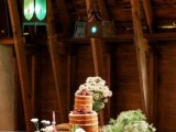 a rustic sweet table a crate and a wooden stand plus some white blooms and greenery is a cool rustic idea